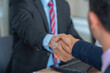 © BESTIMAGE - handshake after partnership meeting success business contract deal. Teamwork congratulate Handshaking for good deal contract agreement partner sign contract paper trust team.