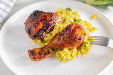 Wall Mural - Barbecue chicken drumsticks with curry brown rice with broccoli on a plate