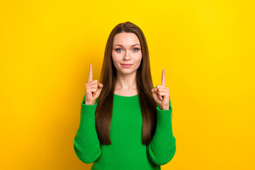 Wall Mural - Portrait of pretty young person indicate fingers up empty space offer isolated on yellow color background