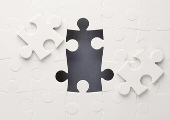 Wall Mural - Unfinished white jigsaw puzzle on yellow background