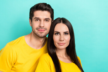 Poster - Photo of dreamy cheerful married couple wear yellow t-shirts embracing empty space isolated teal color background