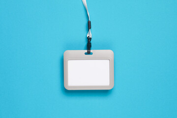 Canvas Print - Blank plastic Id card badge with belt on blue background. Template for design