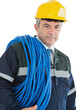Mature man wearing hardhat with cable