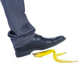 Businessman about to step on banana peel