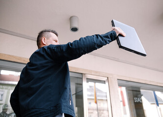 Wall Mural - A confident business person with a laptop in the city. Business vision, communications, online shopping