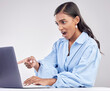 © Phindulo T/peopleimages.com - Shock, laptop and a pointing business woman in shock on a white background in studio while working. Wow, computer and hand gesture with a surprised female employee looking at an online notification