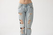 © Sergey Chumakov - ripped jeans on slim beautiful woman isolated on white background