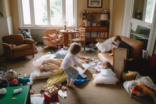Kids Play Imagining In Messy Living Room: Toys, Blankets, Furniture Disarranged. Photo Generative AI