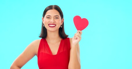 Poster - Paper heart, happy woman and face on blue background, studio and backdrop. Portrait of female model in red dress with shape of love, trust and romance for valentines day, flirting and elegant smile