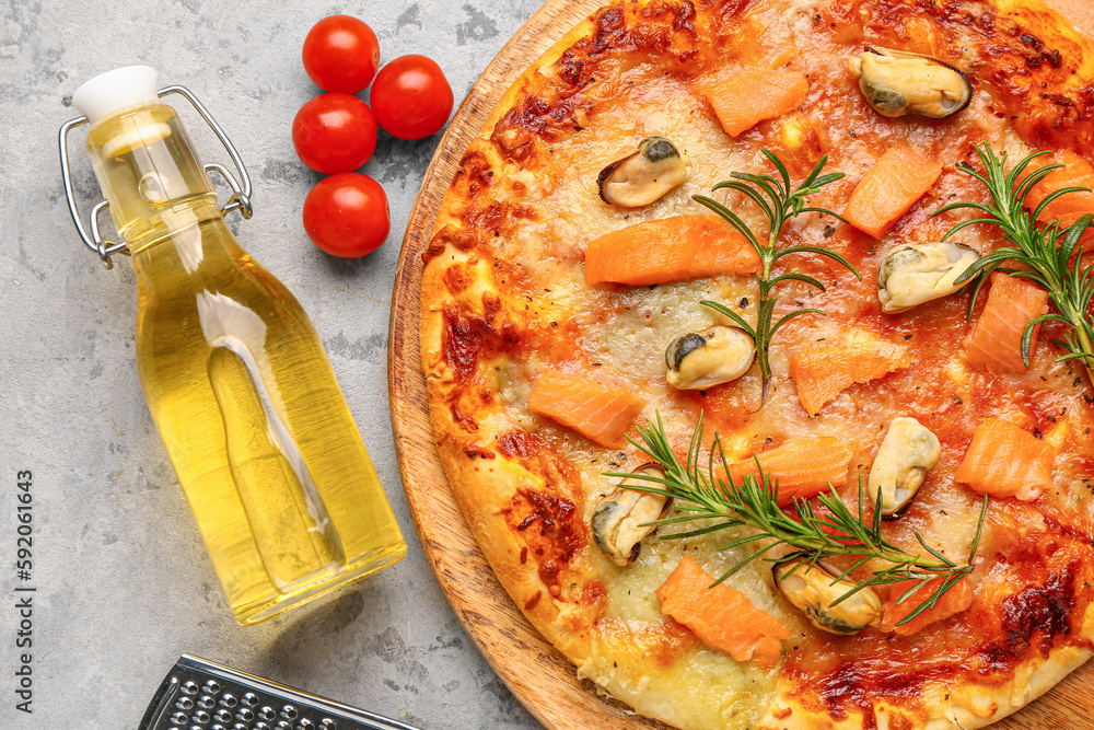 Plate with tasty seafood pizza on grunge background, closeup