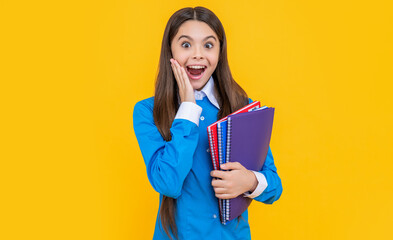 amazed teen school girl isolated on yellow background. teen school girl in studio.