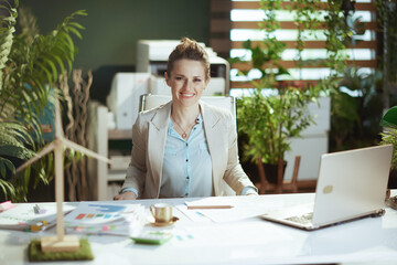 Wall Mural - happy accountant woman in light business suit in green office