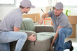 © auremar - two contractor employees moving personal belongings