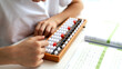 © I - the boy is engaged in mental arithmetic on the abacus