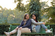 © PRASANNAPIX - Two indian woman sitting at park in winter wear.
