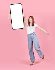 Asian young woman showing smart phone with blank screen , white screen for Mobile App Advertising isolated on pink background ,Cell phone display Mock Up Image.