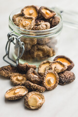 Wall Mural - Dried shiitake mushrooms in jar on kitchen table.