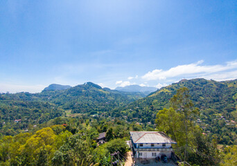 Wall Mural - Beautiful mountain tropical landscape with green hills and tea plantations. Photography for tourism background, design and advertising.