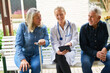 © Robert Kneschke - Female doctor explaining senior people over tablet PC in garden