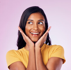 Wall Mural - Excited, beauty and face of happy Indian woman on pink background with smile, confidence and surprise. Happiness, fashion and girl pose with hands in studio with cosmetics, natural makeup and style