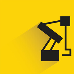 Wall Mural - industrial robotic arm with shadow on yellow background