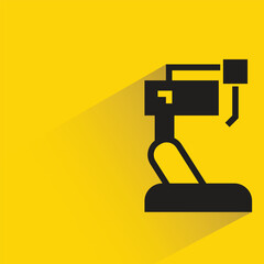 Wall Mural - industrial robotic arm with shadow on yellow background