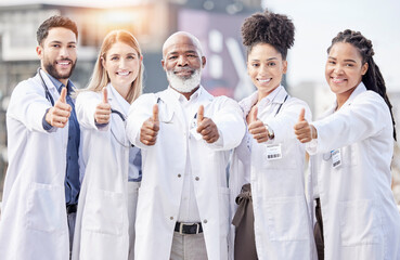 Poster - Portrait, collaboration and thumbs up with a team of doctors standing outside of a hospital together. Teamwork, thank you or motivation with a team of professional healthcare workers feeling positive