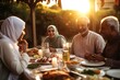 A family sitting together for iftar the breaking of fast at sunset.On the table full of traditional Ramadan foods. The family smiling and laughing. Generative AI