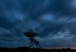 © Kev Kindred/Wirestock Creators - Silhouette shot of a radio telescope dish on a field during dusk