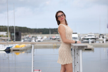 woman in dress near the yachts