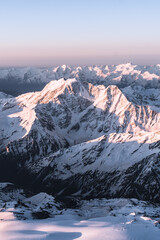 Wall Mural - Snowy mountains at sunrise. Beautiful landscape with snowy rocks