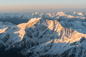 Wall Mural - Snowy mountains at sunrise. Beautiful landscape with snowy rocks