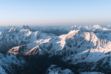 Wall Mural - Snowy mountains at sunrise. Beautiful landscape with snowy rocks