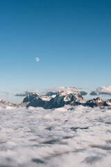 Wall Mural - view of the moon and the caucasian ridge with mount ushba above the clouds