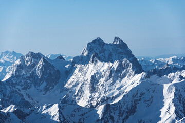 Wall Mural - View of Mount Ushba and snow-covered peaks on a cloudy day from the top of Mount Elbrus