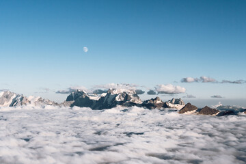 Wall Mural - View of the moon and the Caucasian ridge with Mount Ushba above the clouds