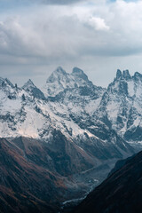 Wall Mural - View of the valley and Mount Ushba and snow-covered peaks on a cloudy day
