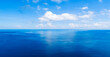 Aerial view of a blue sea surface water texture background and sun reflections,Aerial flying drone view Waves water surface texture on sunny tropical ocean landscape,Nature background