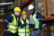 © FotoArtist - Multiethnic industrial workers checking their logistic lists while working with transportation of goods in warehouse
