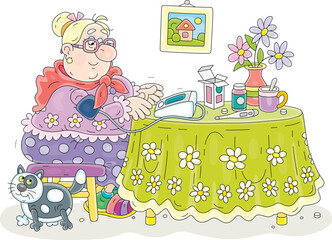 Funny granny sitting at her beautiful kitchen table with flowers and monitoring blood pressure and heart beat with a home medical device, vector cartoon illustration isolated on a white background