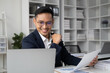 © PaeGAG - Happy Asian businessman working with laptop computer in the white modern office room.