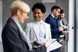 © Novak - Afro American business woman discussing with with middle aged business woman
