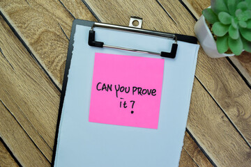 Concept of Can You Prove it? write on sticky notes isolated on Wooden Table.