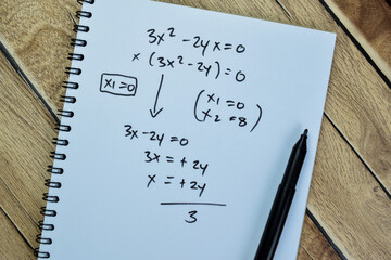 Concept of math formulas write on book isolated on Wooden Table.