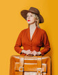 Blonde hair woman in vintage hat and brown dress with suitcase