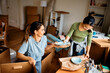 © Drazen - Happy female friends unpacking their belongings while moving into new home.