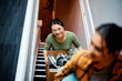 © Drazen - Happy Asian woman and her roommate moving into new apartment.