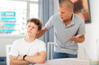 © JackF - Dissatisfied father scolds young son at home