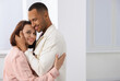 © New Africa - Dating agency. Happy couple enjoying time together at home, space for text