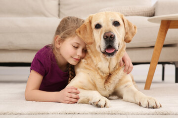 young girl with her adorable dog on floor at home